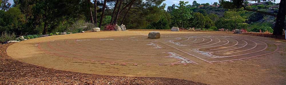 The labyrinth with center stone surrounded by stones and trees