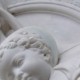 Detail of white marble sculpture depicting Madonna and Child faces